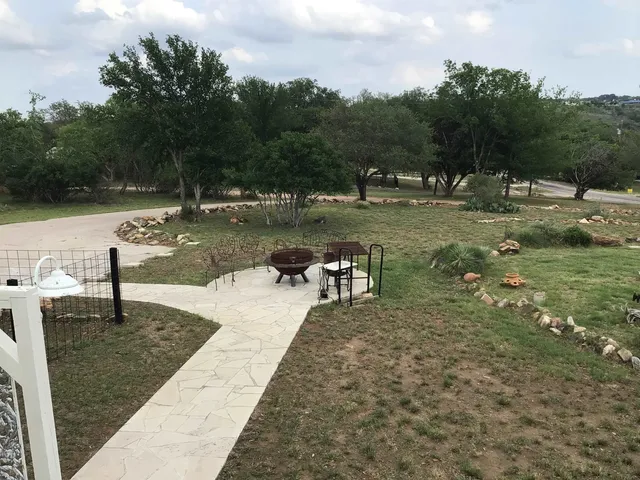 a view of a house with backyard porch and sitting area