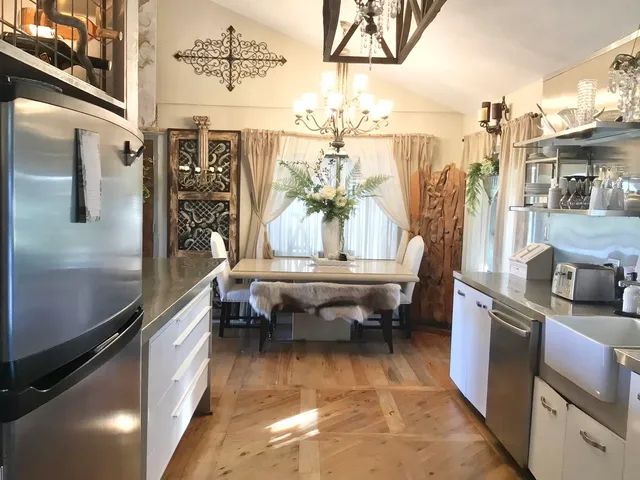 a living room with granite countertop furniture and a flat screen tv