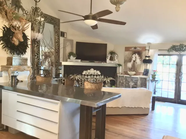 a kitchen with stainless steel appliances granite countertop a sink a stove and refrigerator