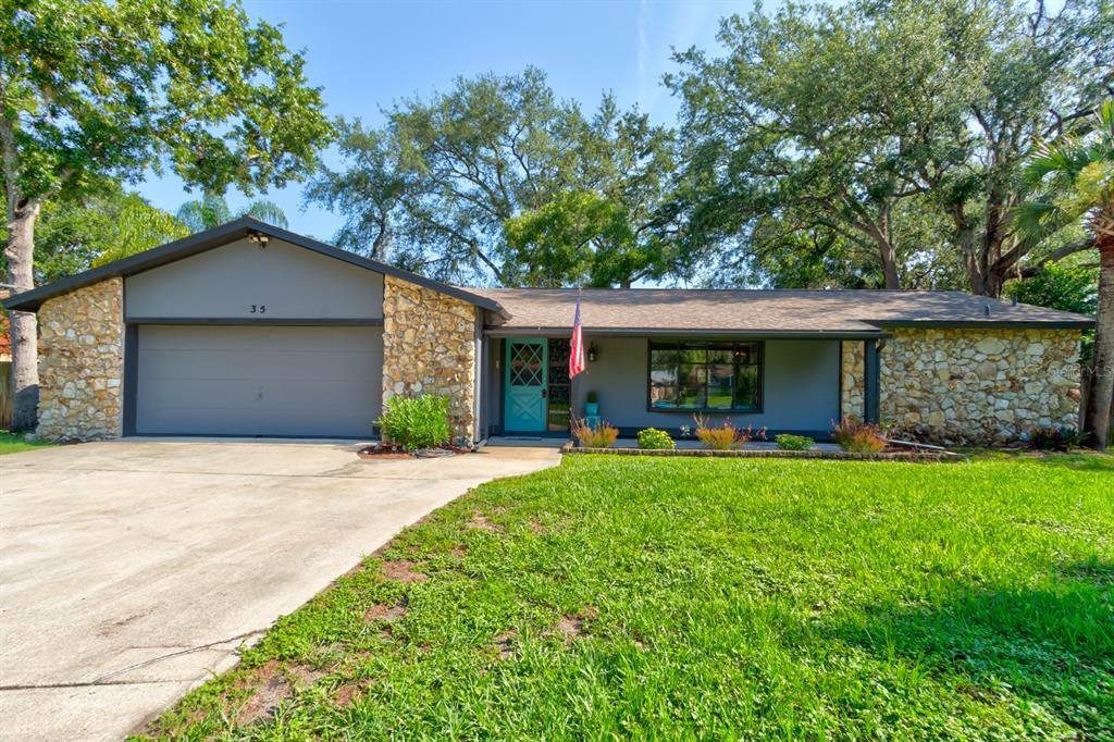 35 Whippoorwill Lane Ormond Beach, FL 32174 - Photo 1 of 1 a front view of a house with swing and garden