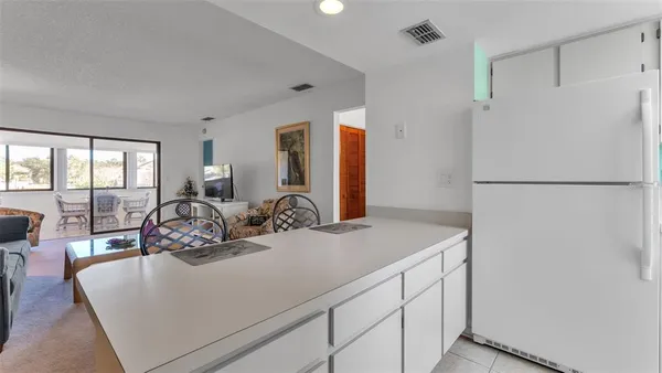 a kitchen with a refrigerator and a sink