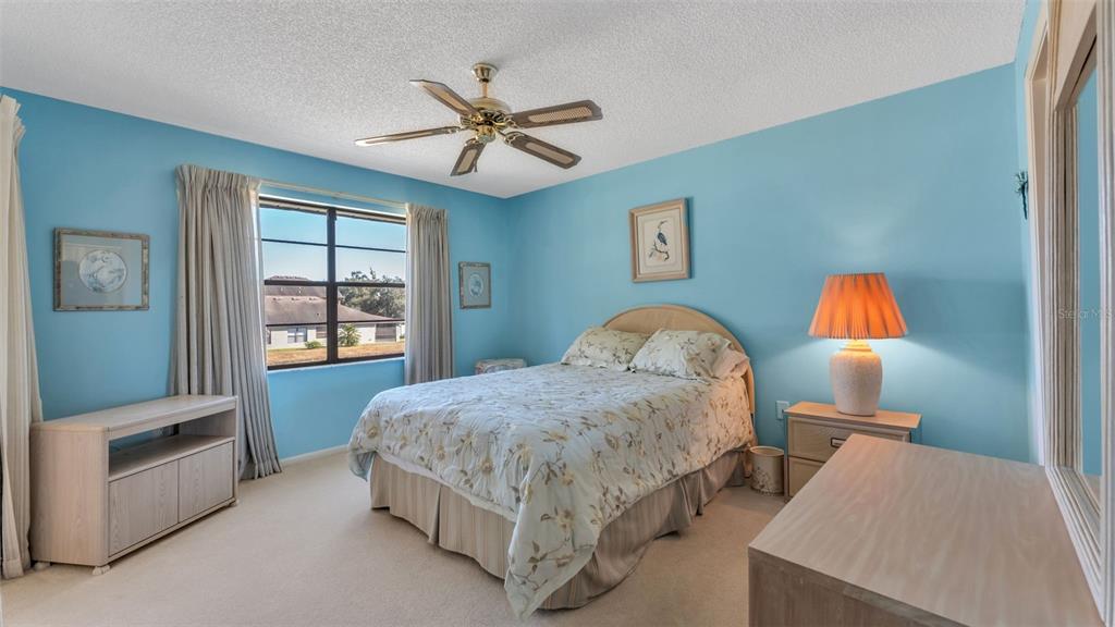 6051 Topher Trail, Unit 6051 Mulberry, FL 33860 - Photo 13 of 38 a living room with a bed furniture and a window