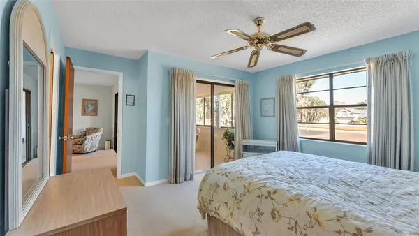 a bedroom with a large bed and a chandelier