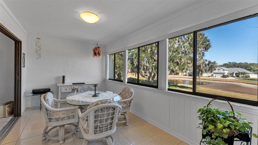 6051 Topher Trail, Unit 6051 Mulberry, FL 33860 - Photo 19 of 38 a dining room with furniture garden view and a potted plant