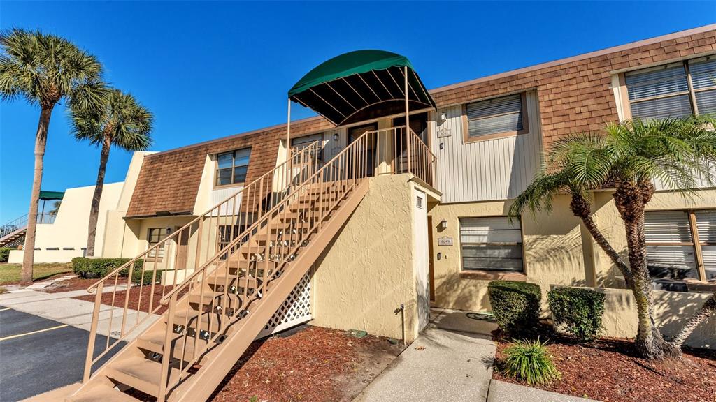 6051 Topher Trail, Unit 6051 Mulberry, FL 33860 - Photo 2 of 38 a front view of a house with a yard