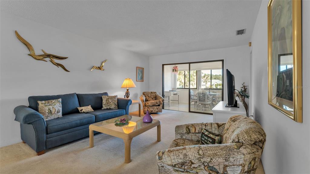 6051 Topher Trail, Unit 6051 Mulberry, FL 33860 - Photo 23 of 38 a living room with furniture and a large window
