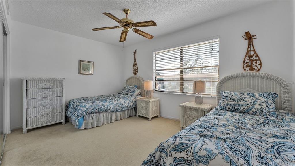 6051 Topher Trail, Unit 6051 Mulberry, FL 33860 - Photo 25 of 38 a bedroom with two beds and a window