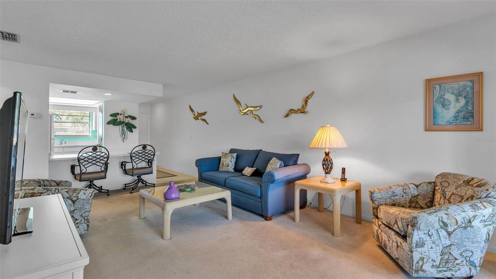 6051 Topher Trail, Unit 6051 Mulberry, FL 33860 - Photo 4 of 38 a living room with furniture and wooden floor