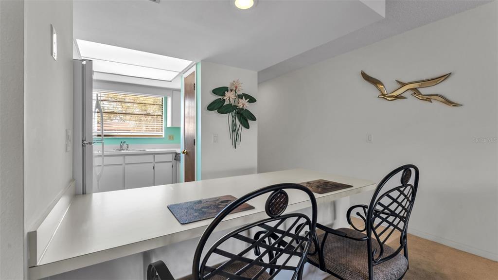 6051 Topher Trail, Unit 6051 Mulberry, FL 33860 - Photo 7 of 38 a view of a dining room with furniture and wooden floor