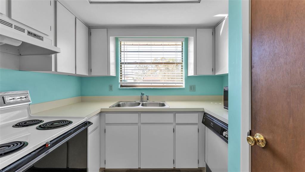 6051 Topher Trail, Unit 6051 Mulberry, FL 33860 - Photo 9 of 38 a kitchen with a sink stove and cabinets