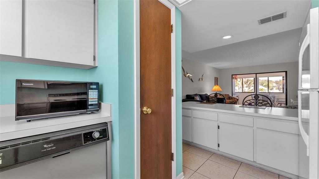 6051 Topher Trail, Unit 6051 Mulberry, FL 33860 - Photo 10 of 38 a kitchen with stainless steel appliances a stove and a microwave