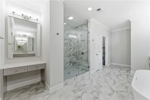 a bathroom with a sink shower and a mirror