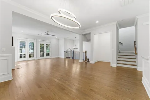 a view of empty room with wooden floor and windows