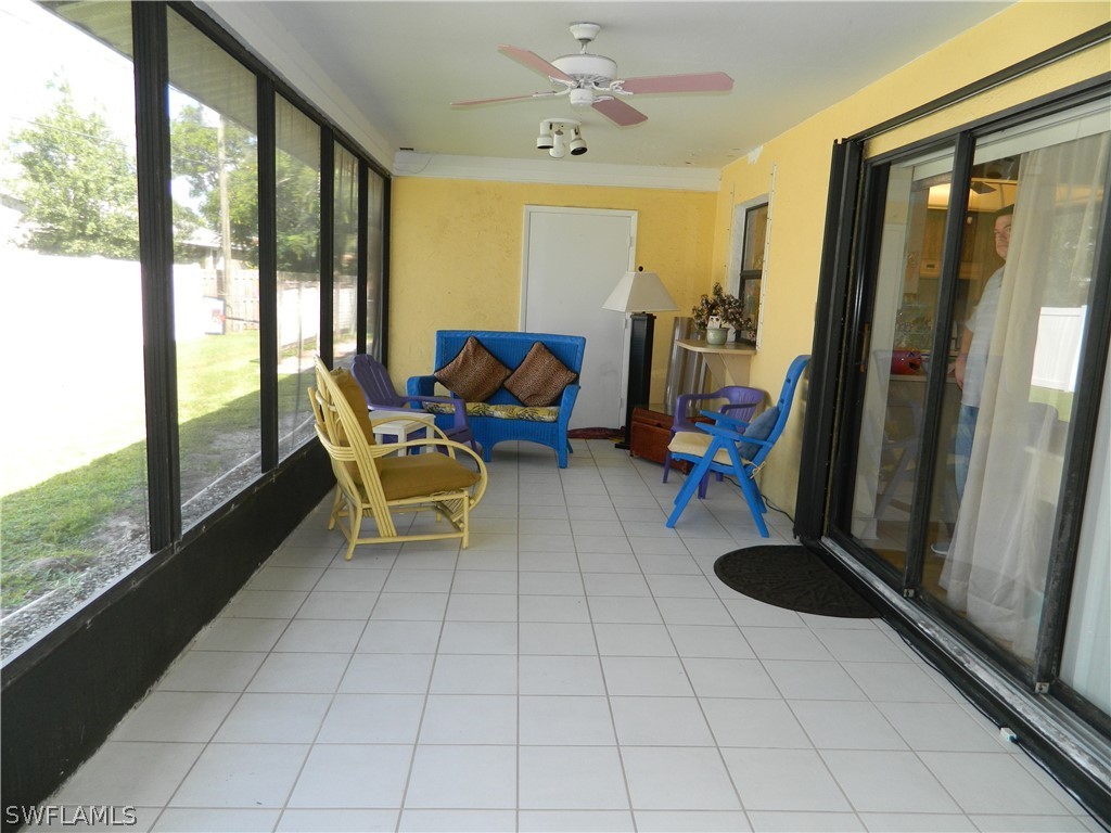 17396 Oriole Road Fort Myers, FL 33967 - Photo 13 of 17 a living room with furniture and a floor to ceiling window