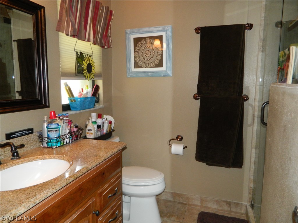 17396 Oriole Road Fort Myers, FL 33967 - Photo 7 of 17 a bathroom with a sink toilet and shower