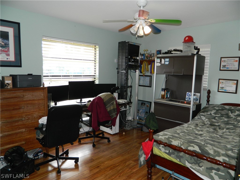 17396 Oriole Road Fort Myers, FL 33967 - Photo 8 of 17 a living room with furniture a desk and chair with wooden floor