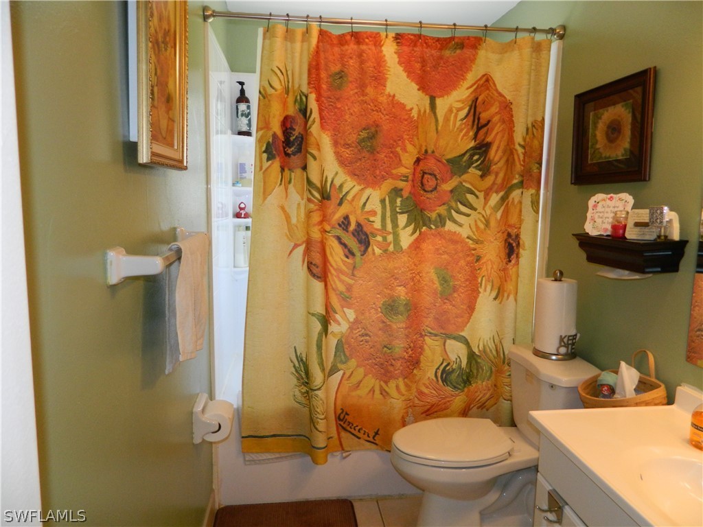 17396 Oriole Road Fort Myers, FL 33967 - Photo 9 of 17 a bathroom with a toilet sink and shower curtain