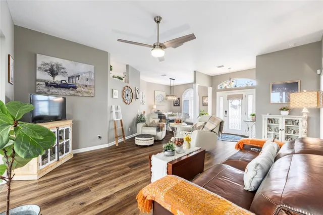 a kitchen that has a lot of white cabinets and stainless steel appliances