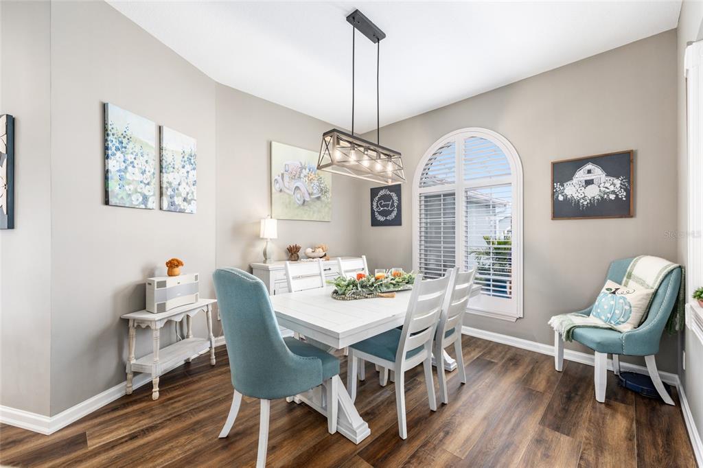 5719 Northwest 25th Loop Ocala, FL 34482 - Photo 21 of 67 a view of a dining room with furniture window and wooden floor