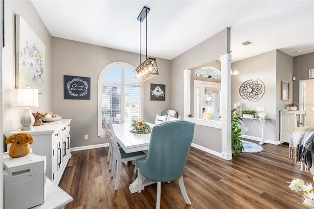 a living room with furniture a chandelier and a window