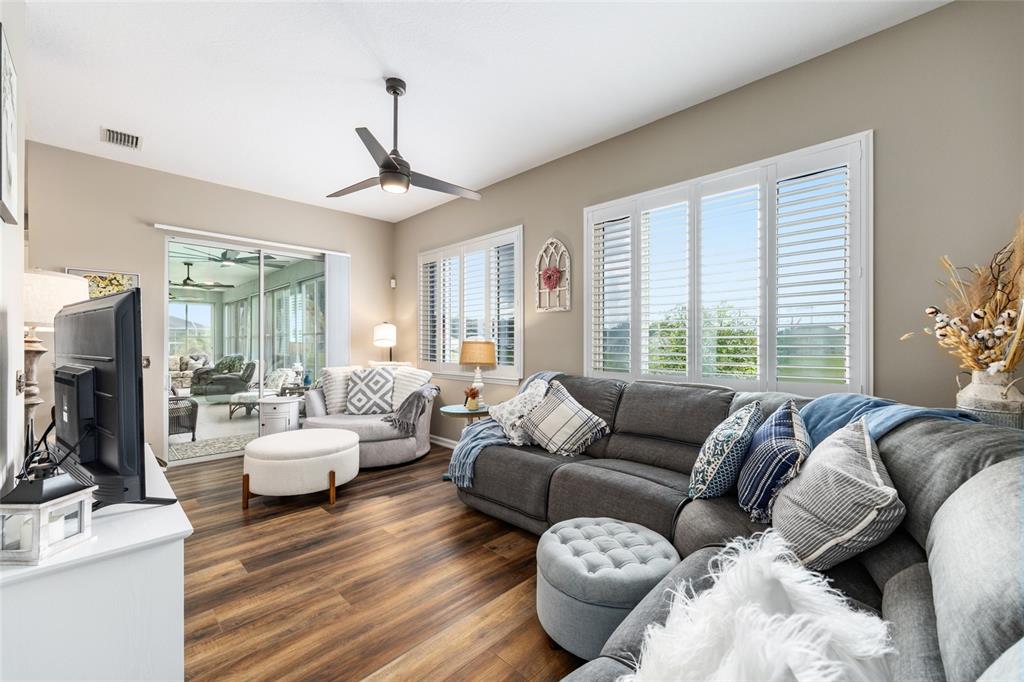 5719 Northwest 25th Loop Ocala, FL 34482 - Photo 29 of 67 a living room with furniture ceiling fan and a window