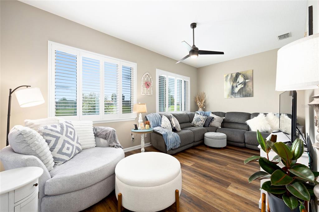 5719 Northwest 25th Loop Ocala, FL 34482 - Photo 30 of 67 a living room with furniture a chandelier and a window