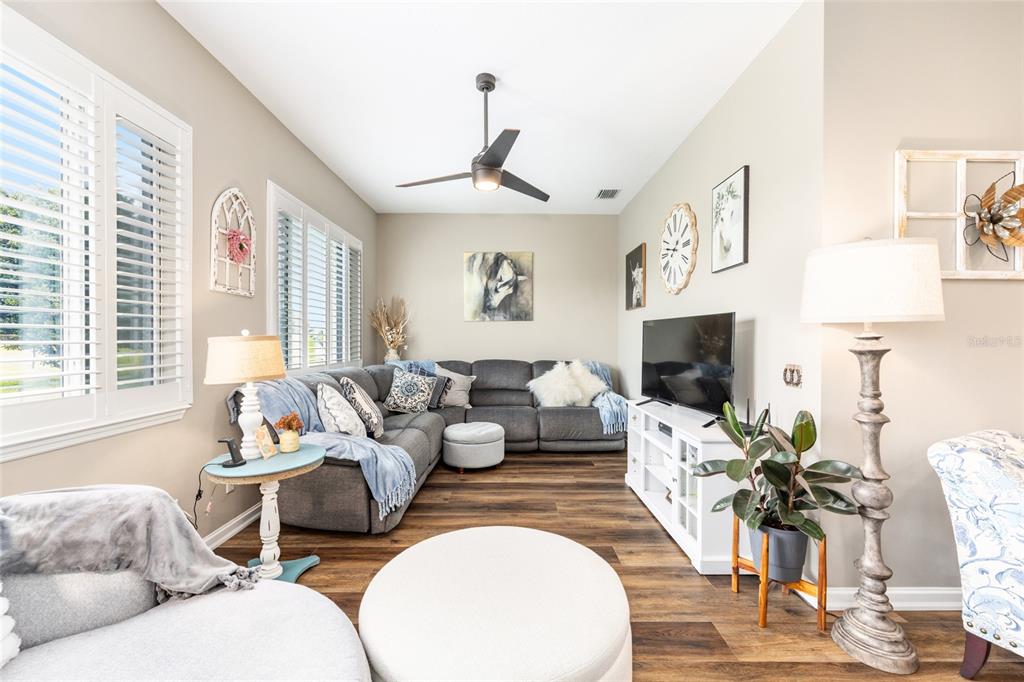 5719 Northwest 25th Loop Ocala, FL 34482 - Photo 31 of 67 a living room with furniture a flat screen tv and a large window