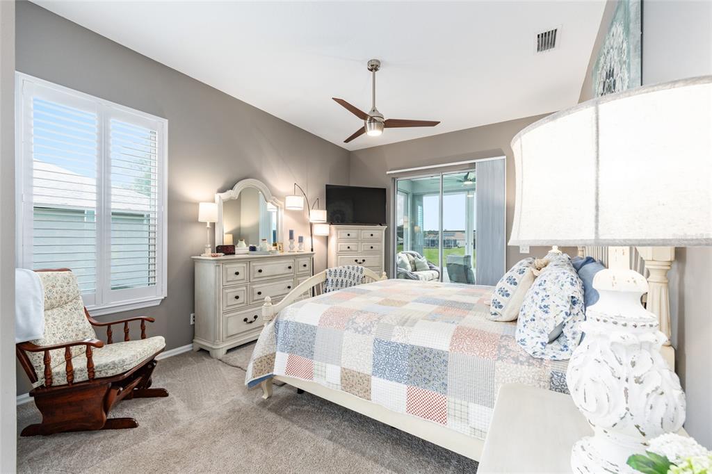 5719 Northwest 25th Loop Ocala, FL 34482 - Photo 33 of 67 a bedroom with a bed a chandelier and dresser