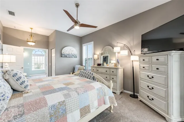 a living room with furniture and a large window with garden view