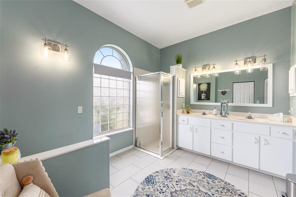 5719 Northwest 25th Loop Ocala, FL 34482 - Photo 37 of 67 a spacious bathroom with a double vanity sink and a mirror