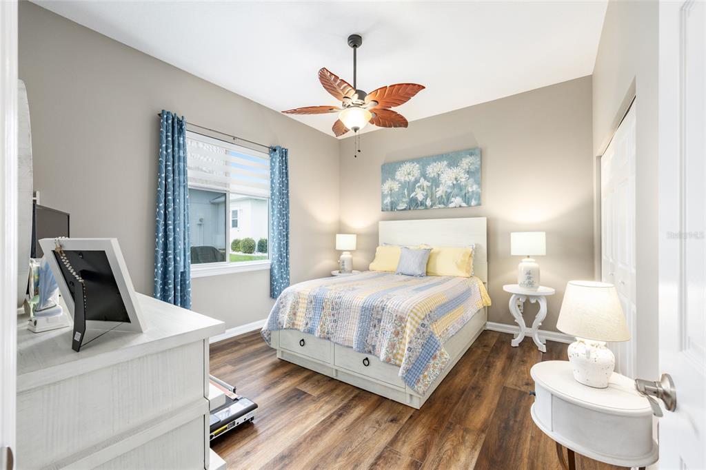 5719 Northwest 25th Loop Ocala, FL 34482 - Photo 38 of 67 a bedroom with a bed wooden floor and a chandelier