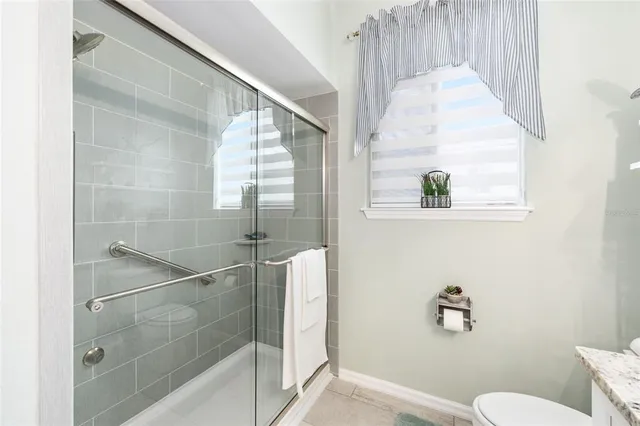 a front view of a house with a garden and yard