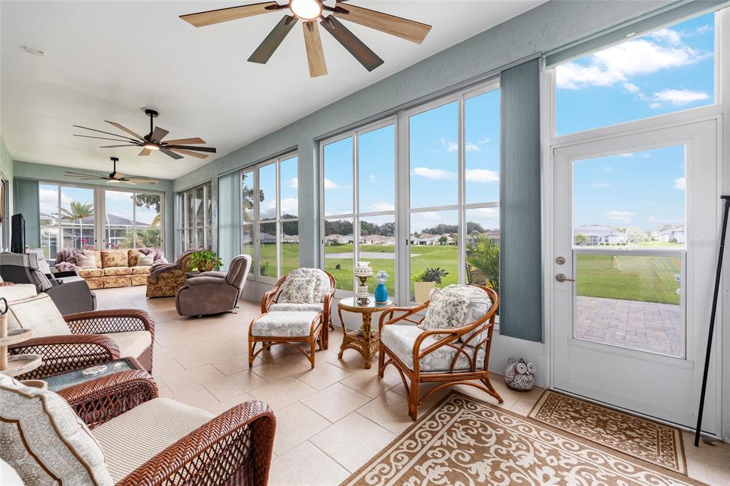 5719 Northwest 25th Loop Ocala, FL 34482 - Photo 44 of 67 a living room with furniture and a floor to ceiling window