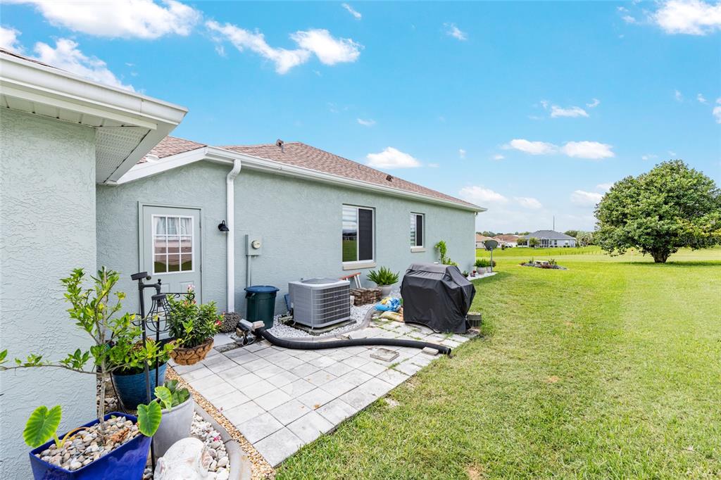 5719 Northwest 25th Loop Ocala, FL 34482 - Photo 52 of 67 a front view of a house with a garden and patio