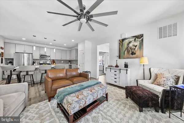 a bedroom with a bed and a dresser next to a window