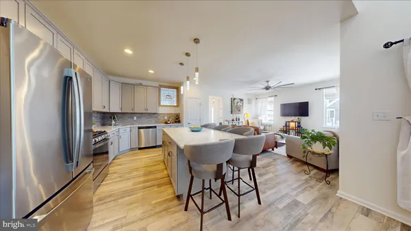 a kitchen with appliances a sink and cabinets