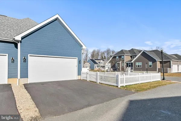 a living room with furniture kitchen view and a chandelier