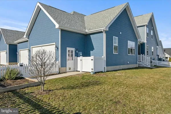 a dining hall with stainless steel appliances lots of wooden furniture a dining table and chairs with wooden floor
