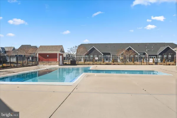 a living room with furniture a window and a ceiling fan