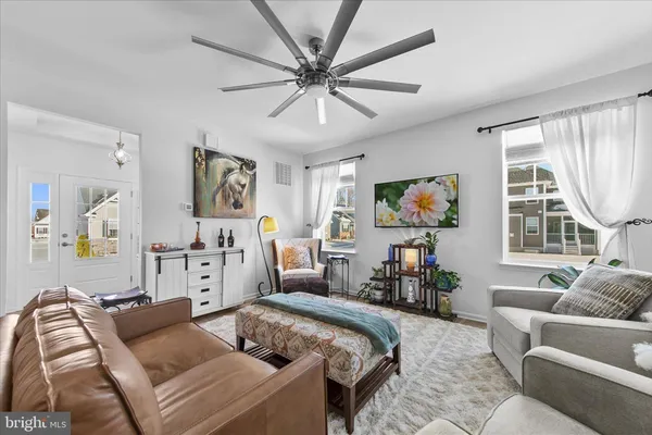 a living room with furniture and kitchen view