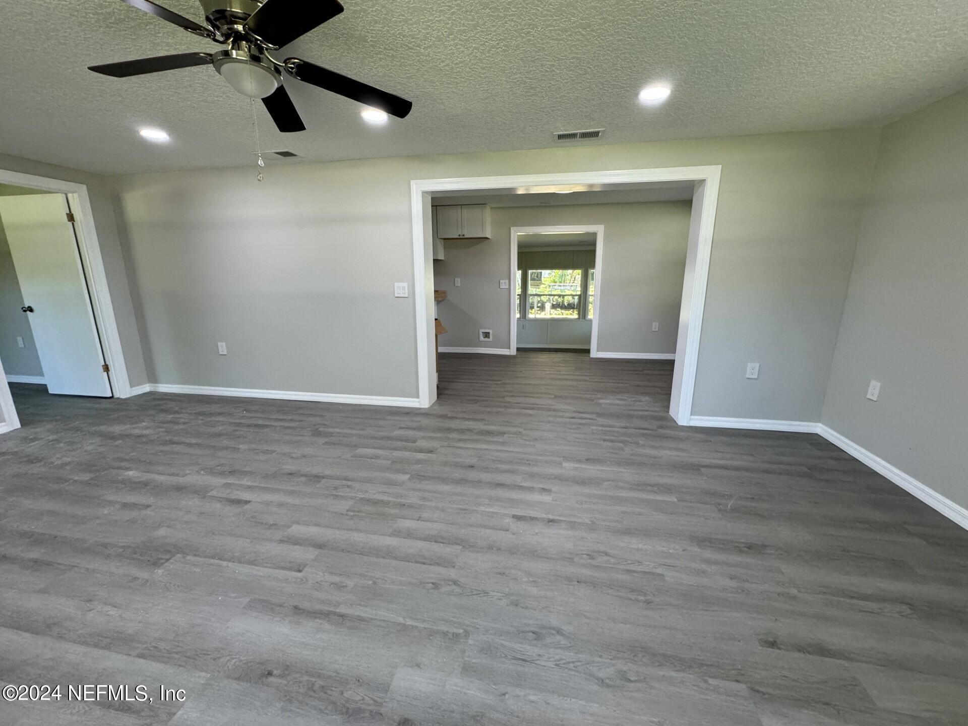 130 Boca Raton Road Satsuma, FL 32189 - Photo 5 of 20 wooden floor and window in an empty room