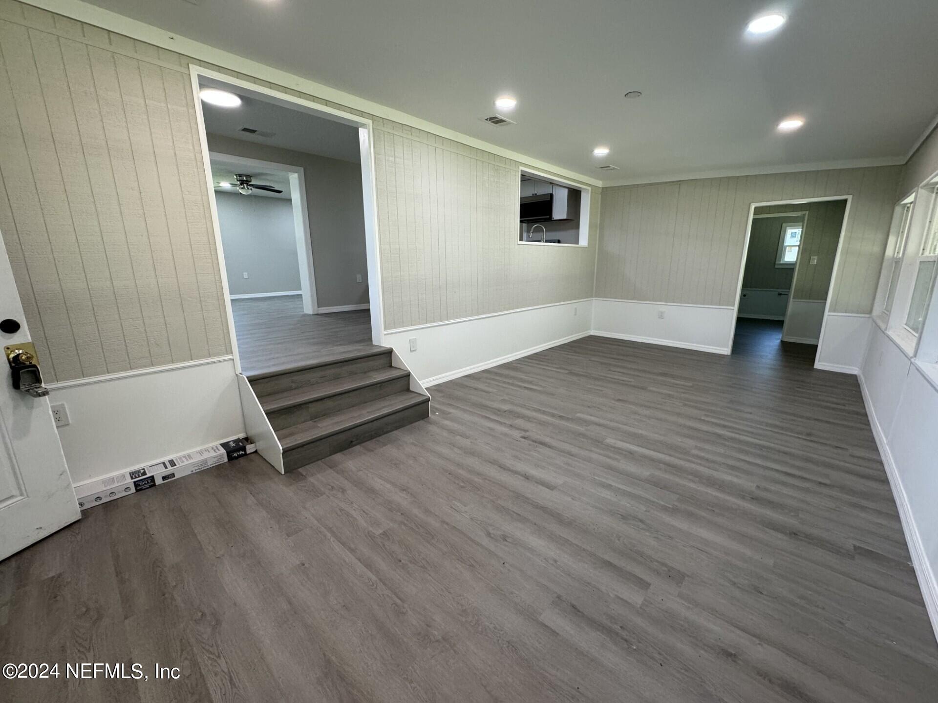 130 Boca Raton Road Satsuma, FL 32189 - Photo 7 of 20 an empty room with wooden floor and windows