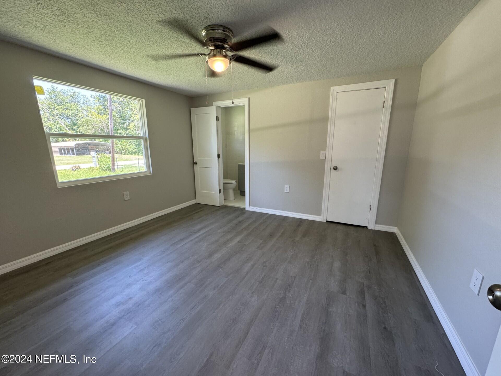 130 Boca Raton Road Satsuma, FL 32189 - Photo 8 of 20 a view of an empty room with wooden floor and a window