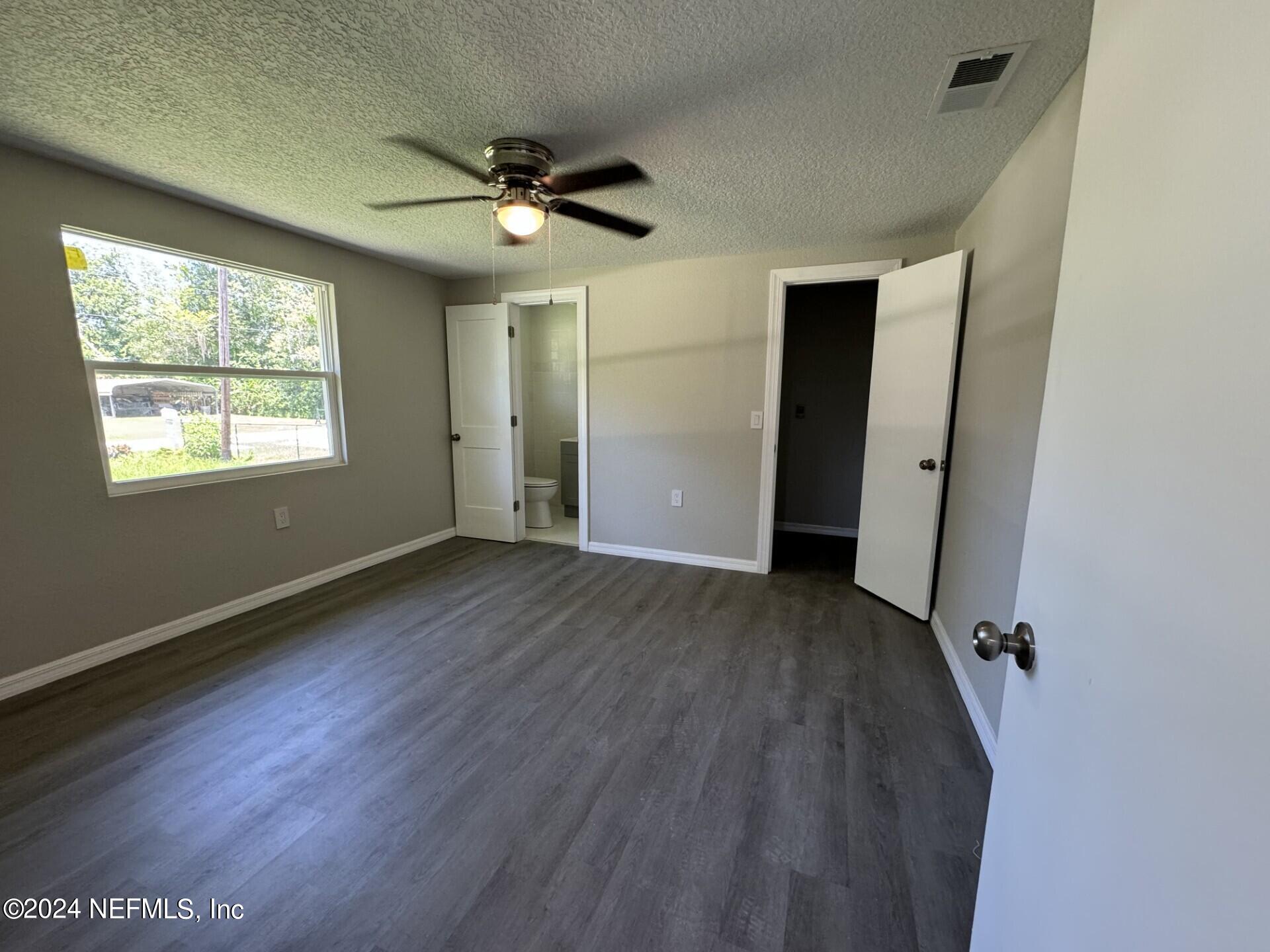 130 Boca Raton Road Satsuma, FL 32189 - Photo 9 of 20 wooden floor in an empty room with a window