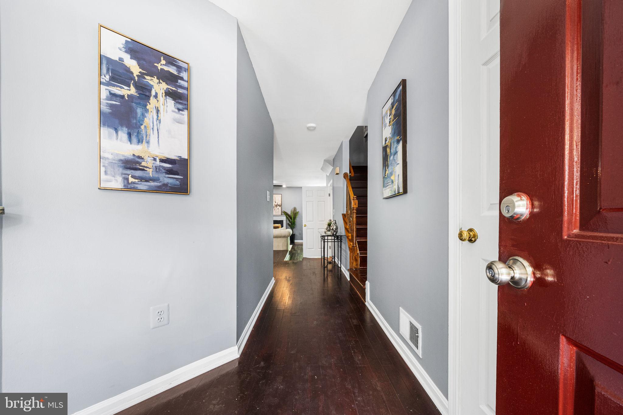 7403 Ridge Oak Court Springfield, VA 22153 - Photo 5 of 54 a view of a hallway with paintings on the wall
