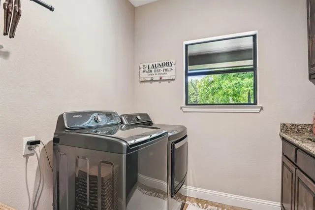 a kitchen with granite countertop a sink and cabinets