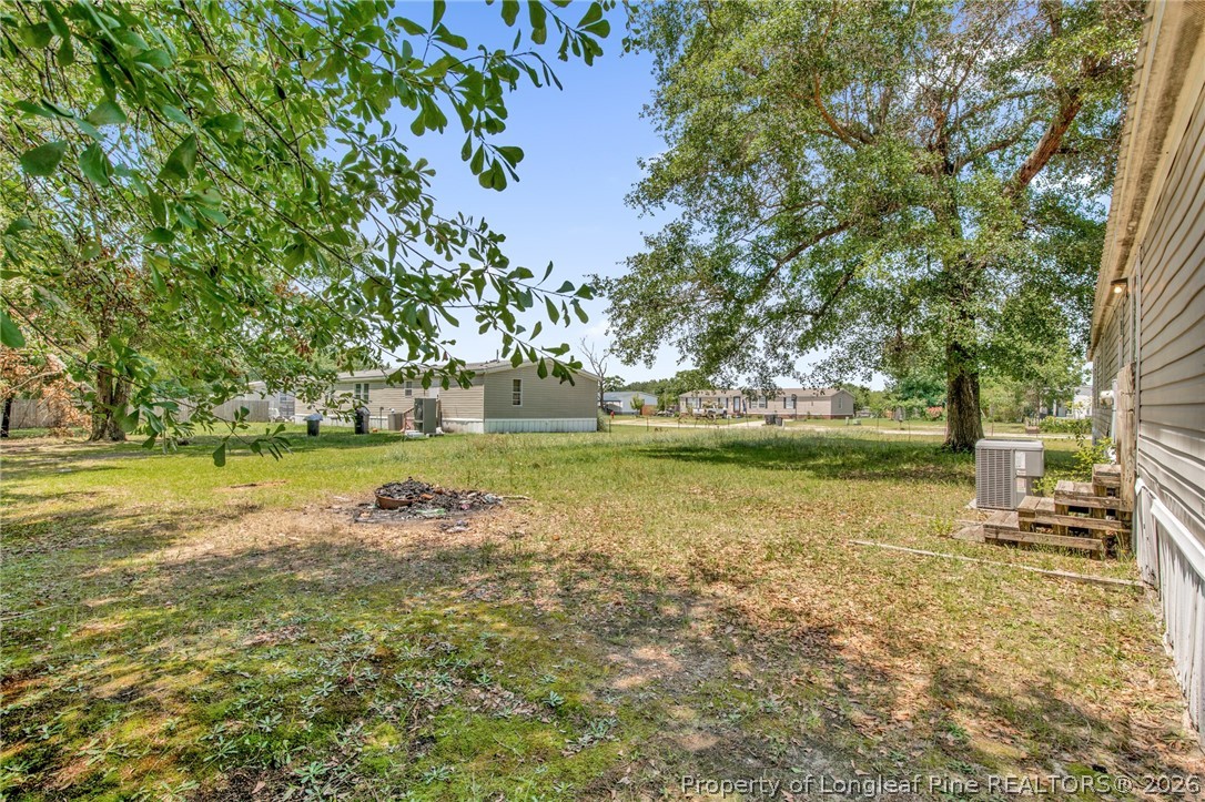 4705 Hickory Ridge Road Parkton, NC 28371 - Photo 37 of 37 a view of a yard with a table and chairs