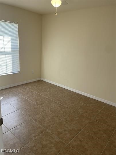 3818 Southwest 16th Place, Unit 3818 Cape Coral, FL 33914 - Photo 3 of 10 an empty room with a empty space and a window