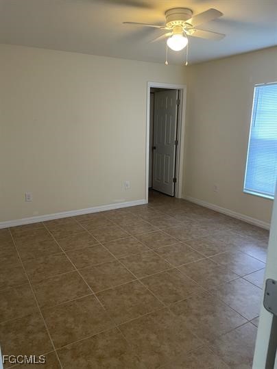 3818 Southwest 16th Place, Unit 3818 Cape Coral, FL 33914 - Photo 9 of 10 en empty room with window and wooden floor