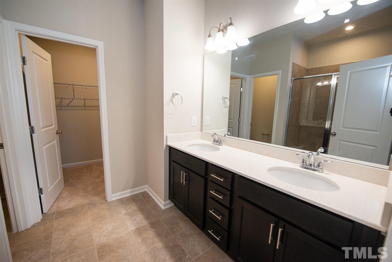 3641 Water Mist Lane, Unit 11 Raleigh, NC 27604 - Photo 14 of 30 a bathroom with a double vanity sink a and a mirror